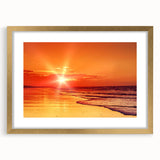 Framed wall art collection featuring a serene seascape design with a gold mat, showcasing calming ocean waves and a sunset. Perfect for coastal home decor.