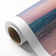 Rolled canvas showcasing a serene seascape design with vibrant blues and soft whites, elegantly packaged in a protective cardboard tube for easy display.