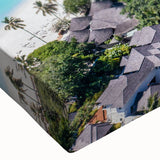 Close-up of a vibrant stretched canvas wall art piece showcasing a serene seascape design with rich blues and soft whites, perfect for coastal decor.