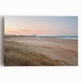 Stretched canvas wall art showcasing a serene seascape design with soft waves and a sunset palette, perfect for coastal-themed decor in living spaces.