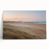 Stretched canvas artwork showcasing a vibrant coastal landscape with serene blue waters and a golden sunset, perfect for enhancing modern home decor.