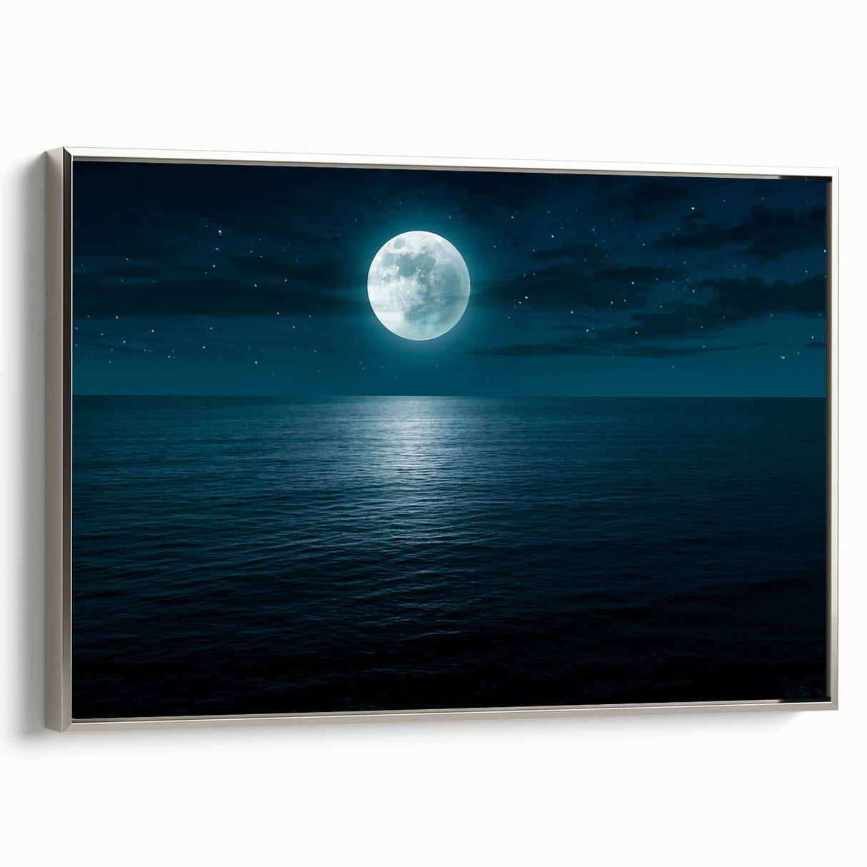 Framed canvas wall art from the Landscapes & Seascapes collection, showcasing serene ocean waves in soft blues and whites, elegantly highlighted with a silver frame.