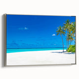 Framed canvas wall art showcasing serene seascape design with vibrant blues and soft whites, elegantly displayed with a silver frame, perfect for coastal decor.
