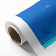 Rolled canvas artwork showcasing a vibrant seascape design in soothing blues and greens, elegantly packaged in a protective cardboard tube for easy storage and display.