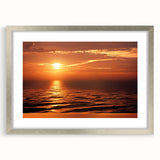 Framed wall art showcasing a serene seascape design with vibrant blues and soft whites, complemented by a silver mat and frame, perfect for coastal decor.