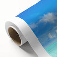 Rolled canvas showcasing a vibrant seascape design with rich blues and greens, ideal for home decor, elegantly packaged in a protective cardboard tube.