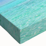 Close-up of a vibrant stretched canvas featuring a serene seascape design with rich blues and soft whites, ideal for home decor and coastal themes. This wall art collection adds a calming touch to any room.