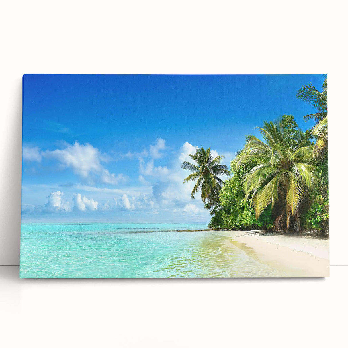 Stretched canvas wall art showcasing a serene seascape design with soft blue and green hues, elegantly leaning against a wall in a bright, airy room.
