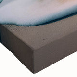 Close-up of a vibrant stretched canvas artwork showcasing an abstract seascape design, featuring rich blue and green hues, ideal for modern home decor.