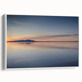 Framed canvas wall art showcasing a serene seascape design with soft blue and white hues, elegantly displayed in a sleek white frame, perfect for coastal-themed decor.