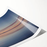 Rolled print of a serene seascape featuring vibrant blues and soft sandy tones, showcasing a tranquil beach scene with gentle waves, perfect for coastal decor.