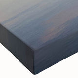 Close-up of a stretched canvas wall art piece featuring a serene seascape design with vibrant blues and greens, ideal for home decor and coastal themes.