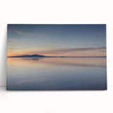 Stretched canvas artwork showcasing a serene seascape design with vibrant blues and soft whites, perfect for coastal-themed decor, leaning against a neutral wall.