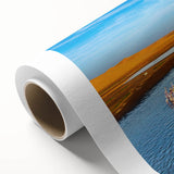 Vibrant rolled canvas artwork depicting a serene seascape with soft waves and a colorful sunset, ideal for enhancing home decor aesthetics.