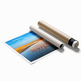 Rolled print showcasing a vibrant seascape design in blues and greens, ideal for home decor, presented in protective cardboard tube packaging.