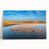 Stretched canvas artwork showcasing a serene seascape with vibrant blues and soft whites, elegantly leaning against a wall, perfect for modern coastal decor.