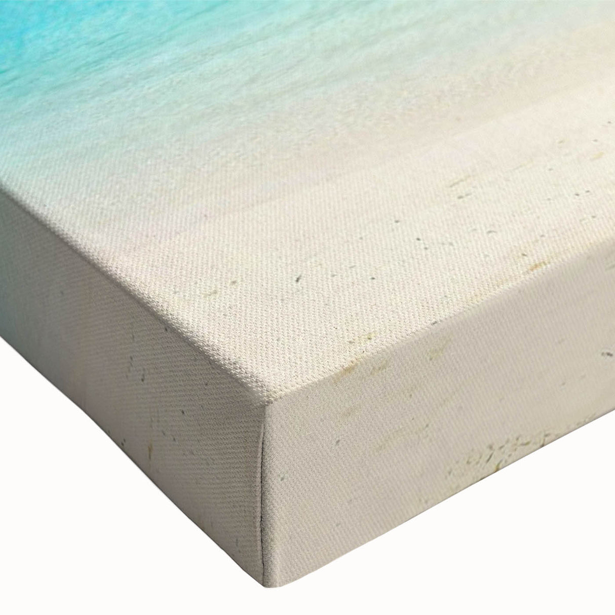 Close-up of a stretched canvas wall art from the Landscapes & Seascapes collection, showcasing vibrant ocean waves in shades of blue and white, perfect for coastal decor.