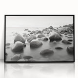 Framed acrylic wall art showcasing a serene seascape with soft blue and white tones, elegantly presented in a sleek black frame, perfect for modern home decor.