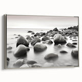 Framed canvas wall art from the Landscapes & Seascapes collection, showcasing serene coastal scenery with soft blues and greens, elegantly displayed with a silver frame.