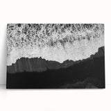 Stretched canvas wall art collection showcasing vibrant landscapes and seascapes, elegantly leaning against a neutral wall, ideal for home decor enhancement.