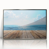 Framed acrylic wall art featuring a serene seascape design with silver accents, ideal for modern home decor. The piece showcases calming ocean waves and a tranquil sky.