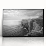 Framed wall art featuring a vibrant seascape design with rich blue and green hues, elegantly displayed in a sleek black frame to enhance any decor.