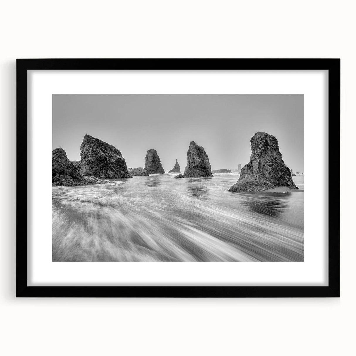 Framed wall art featuring a serene seascape design in a black frame with a white mat, showcasing calming ocean waves and a clear blue sky, perfect for home decor.