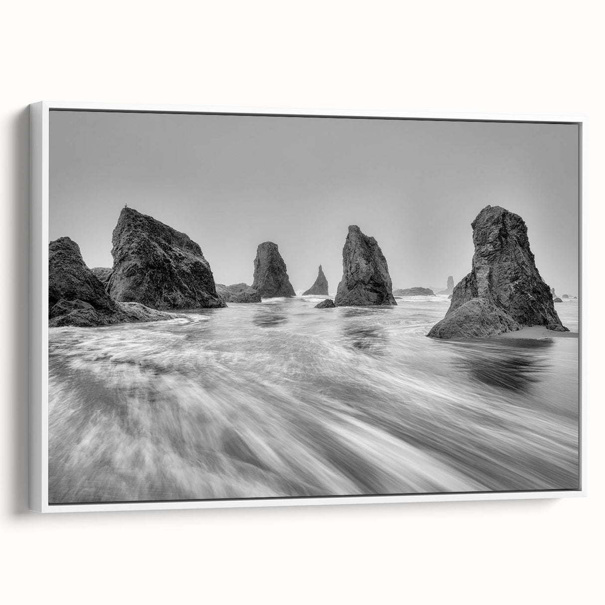 Framed canvas artwork from the Landscapes & Seascapes collection showcasing serene ocean waves in soft blues and whites, perfect for coastal home decor.
