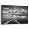 Framed canvas wall art showcasing a serene seascape design, featuring calming blue and white hues, ideal for home decor. The black frame adds elegance to any room.