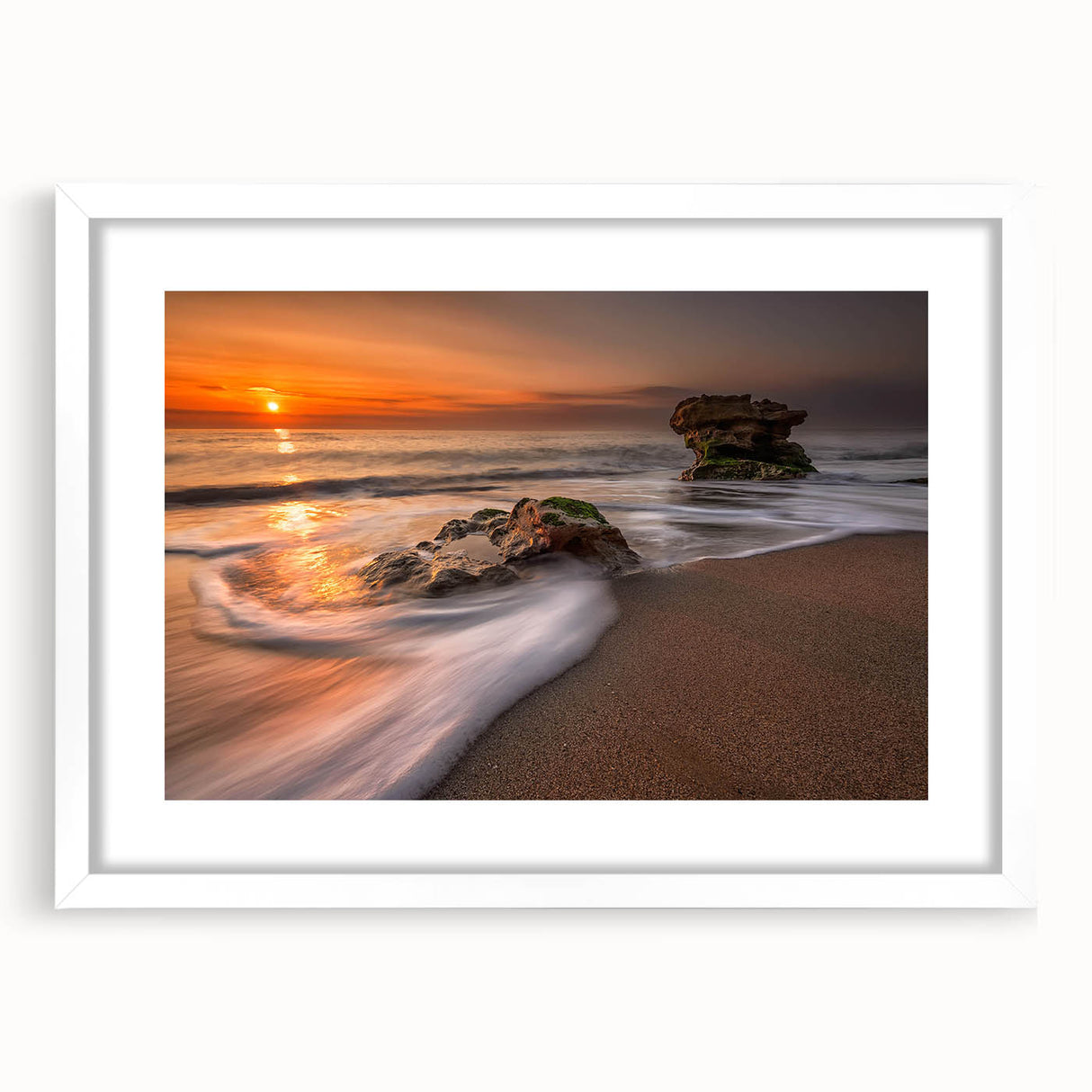 Framed wall art from the Landscapes Seascapes collection, featuring a serene coastal scene with soft blue and white hues, designed to enhance modern decor.