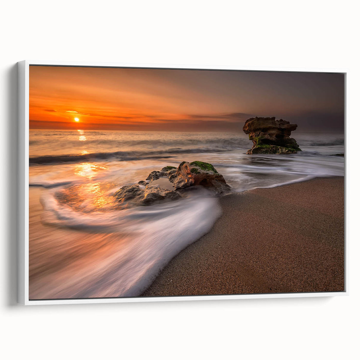 Framed canvas wall art showcasing a serene seascape design in calming blue and white tones, presented in a sleek white frame, ideal for coastal-themed decor.