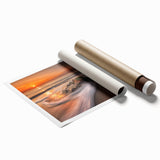 Stunning rolled print of a serene seascape featuring vibrant blues and soft whites, showcasing waves crashing against a rocky shoreline, ideal for coastal decor.
