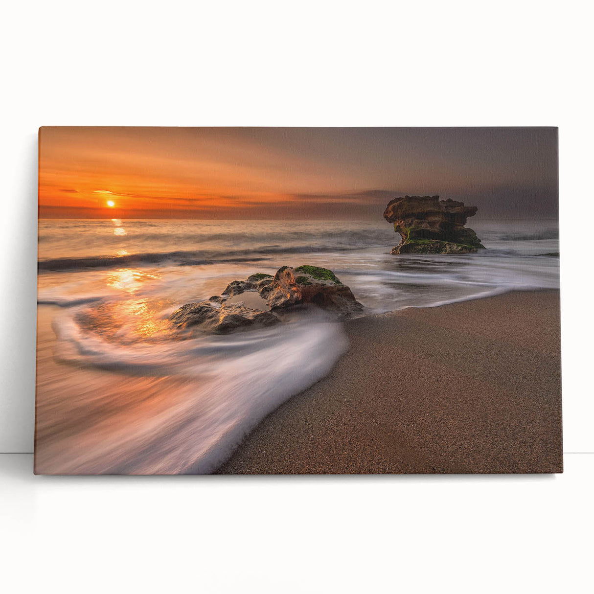 Stretched canvas artwork showcasing a vibrant seascape design with blue and green hues, leaning against a neutral wall, adding a serene touch to home decor.