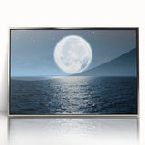 Framed wall art featuring a scenic seascape design with vibrant blues and soft whites, showcasing a serene ocean view in a sleek silver frame, perfect for modern decor.