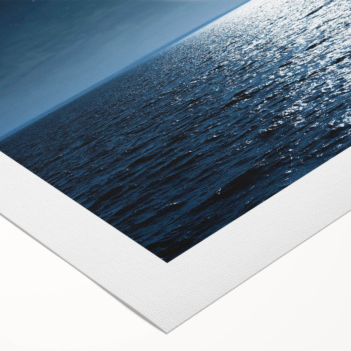 Rolled canvas showcasing a vibrant seascape design with waves and a sunset, ideal for coastal-themed decor, securely packaged in a protective tube.
