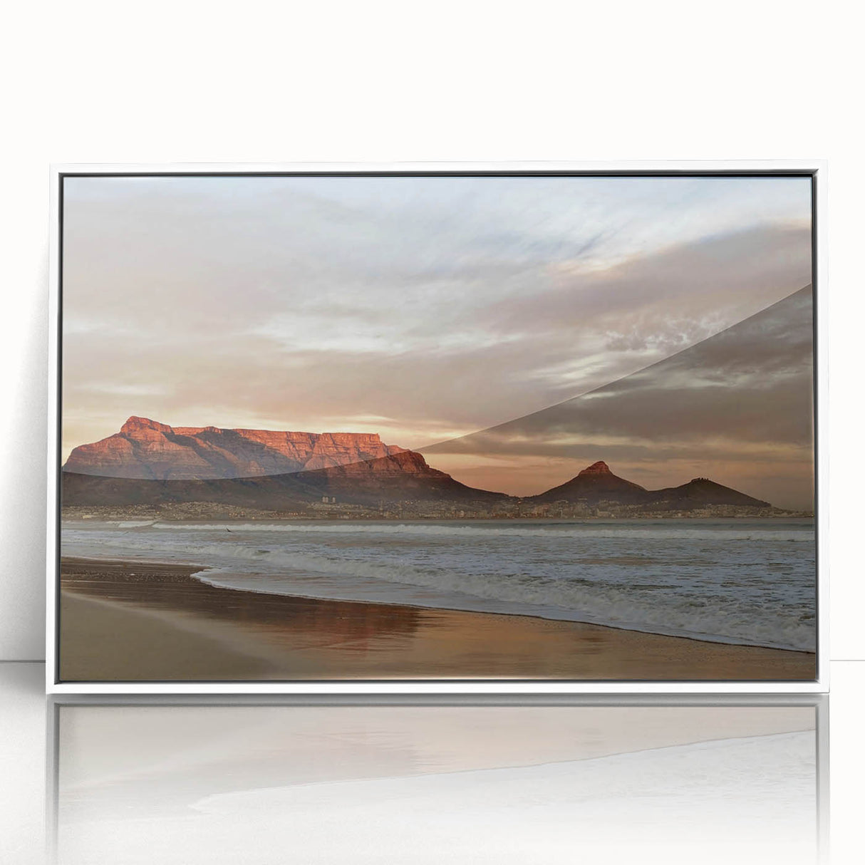 Framed wall art design showcasing a serene seascape with soft blue and white tones, ideal for coastal decor, mounted in a sleek white frame.