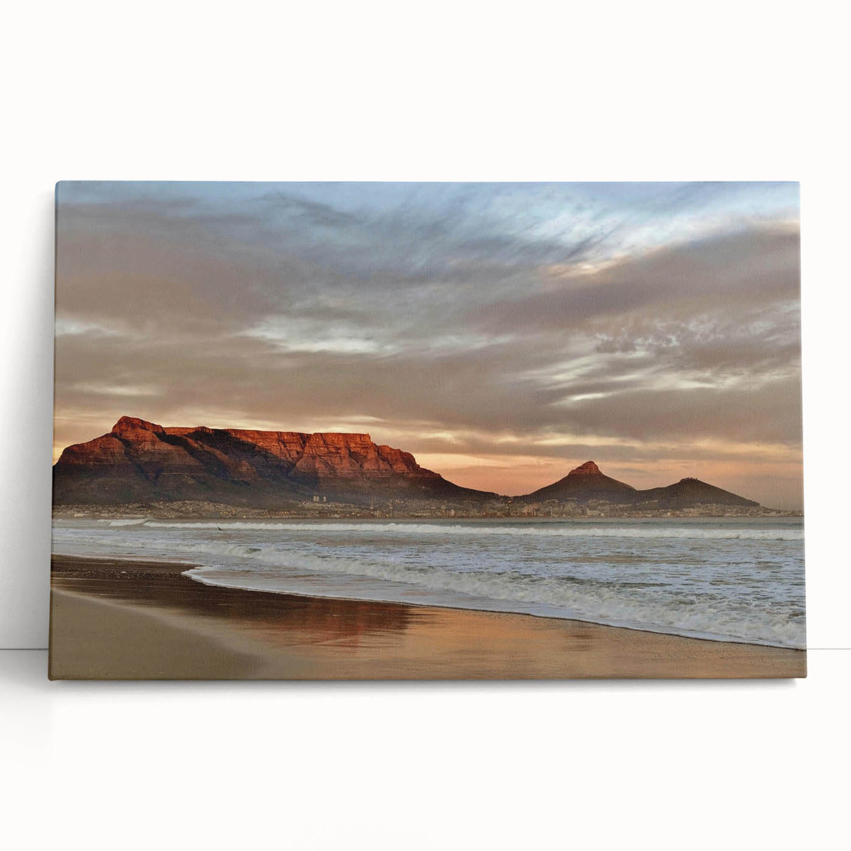 Stretched canvas wall art showcasing a serene seascape design with soft blue and green hues, elegantly leaning against a white wall, ideal for coastal decor.