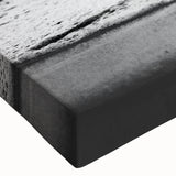 Close-up of a stretched canvas wall art piece depicting a vibrant seascape, showcasing swirling blues and greens with textured brush strokes, ideal for coastal decor.