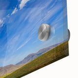 Close-up of an elegant acrylic glass wall art piece showcasing a vibrant landscape with rich colors and fluid designs, ideal for modern home decor.