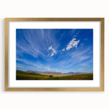 Framed wall art collection showcasing a serene landscape design with vibrant colors and a gold mat, ideal for enhancing modern home decor. The artwork captures a tranquil sky and natural scenery, perfect for adding elegance to living spaces.