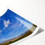 Vibrant landscape wall art print showcasing a serene skyscape with dramatic clouds and soft hues, rolled for easy display and shipping in a protective tube.