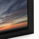 Framed canvas wall art featuring a vibrant landscape design with rich colors showcasing a sunset over rolling hills, perfect for home decor accents.