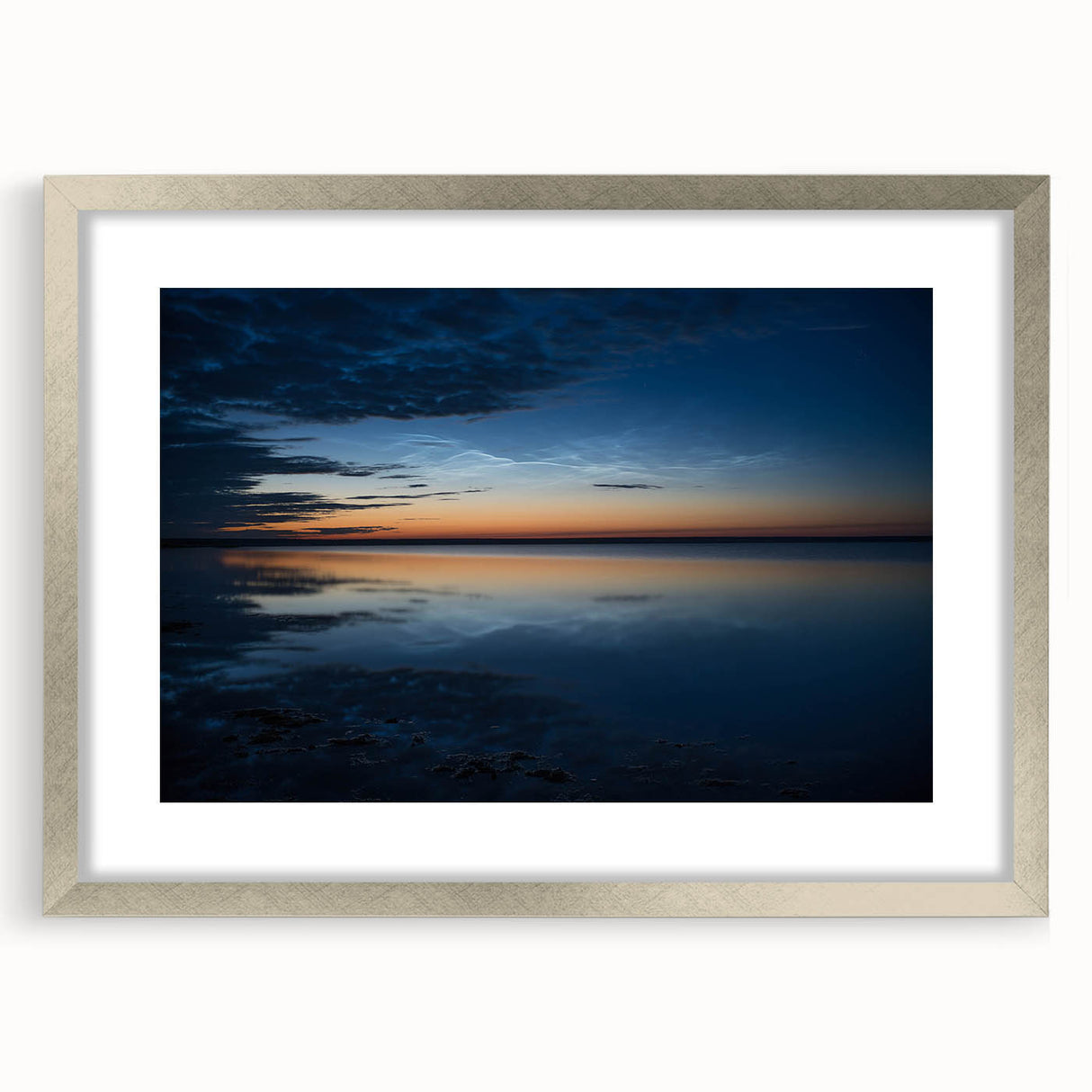 Framed wall art collection showcasing a serene landscape with soft blue and green tones, featuring a silver frame and mat for an elegant presentation, ideal for home decor.