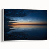 Framed canvas wall art featuring a serene landscape with soft blue skies and white clouds, showcasing a modern design. The artwork is elegantly displayed with a white frame, enhancing its aesthetic appeal for home decor.