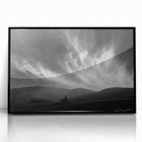 Framed acrylic wall art featuring a serene landscape with soft blue skies and lush greenery, set in a sleek black frame, ideal for modern home decor.