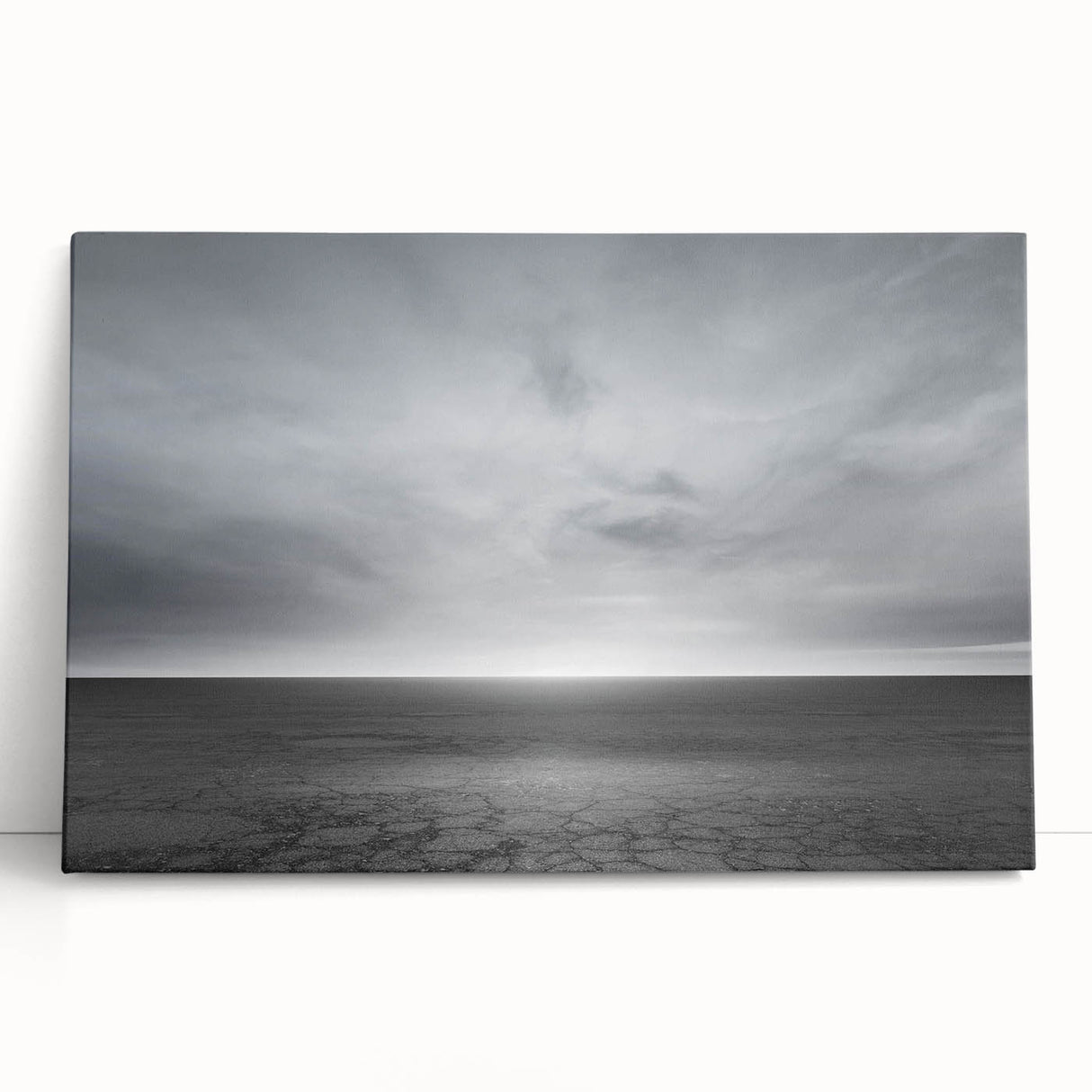 Stretched canvas wall art featuring a serene landscape design with soft pastel colors, leaning against a neutral backdrop, ideal for home decor enhancement.