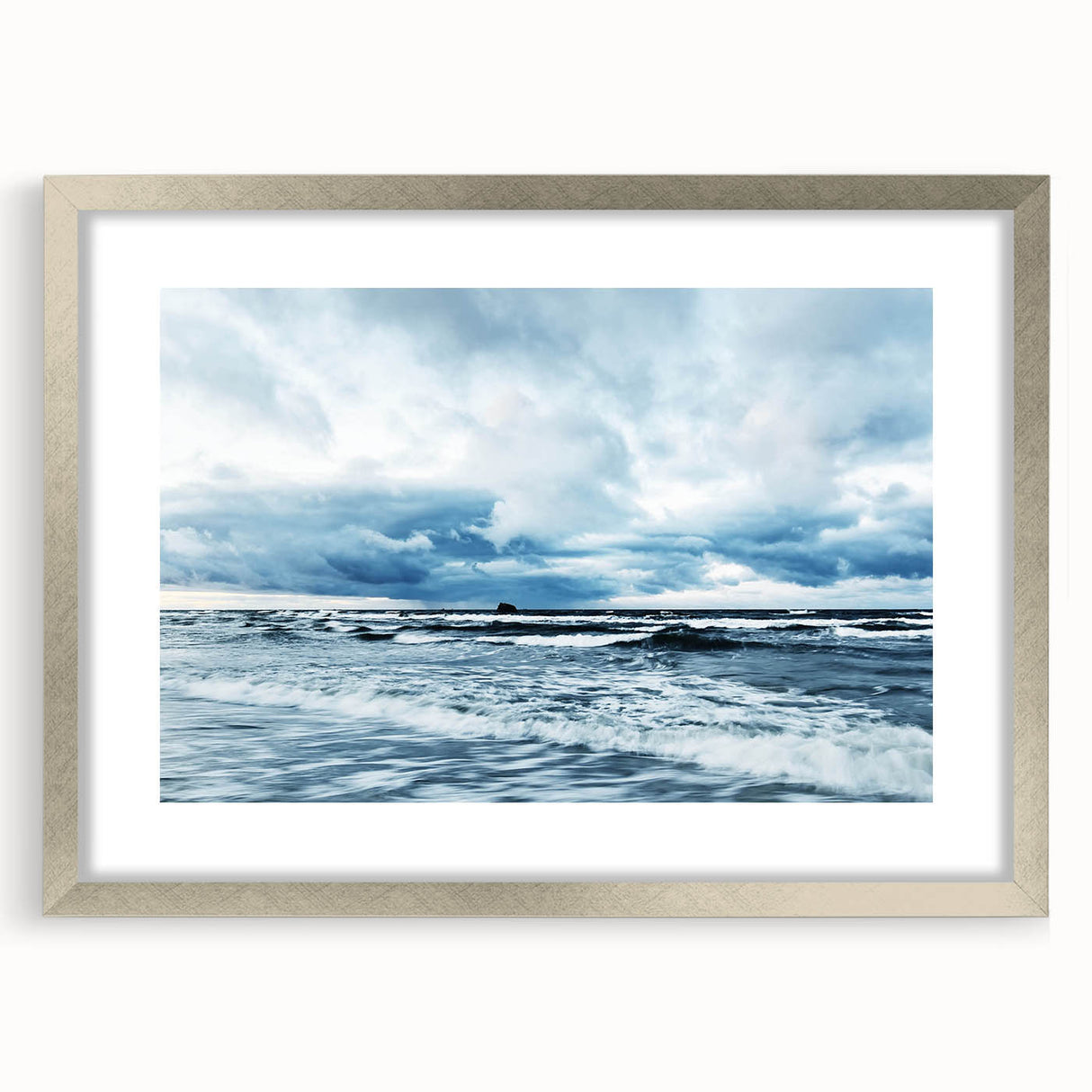 Framed wall art collection showcasing a serene landscape with soft skies, presented in a sleek silver frame with a white mat, perfect for modern decor.