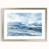 Framed wall art collection showcasing a serene landscape with soft skies, presented in a sleek silver frame with a white mat, perfect for modern decor.