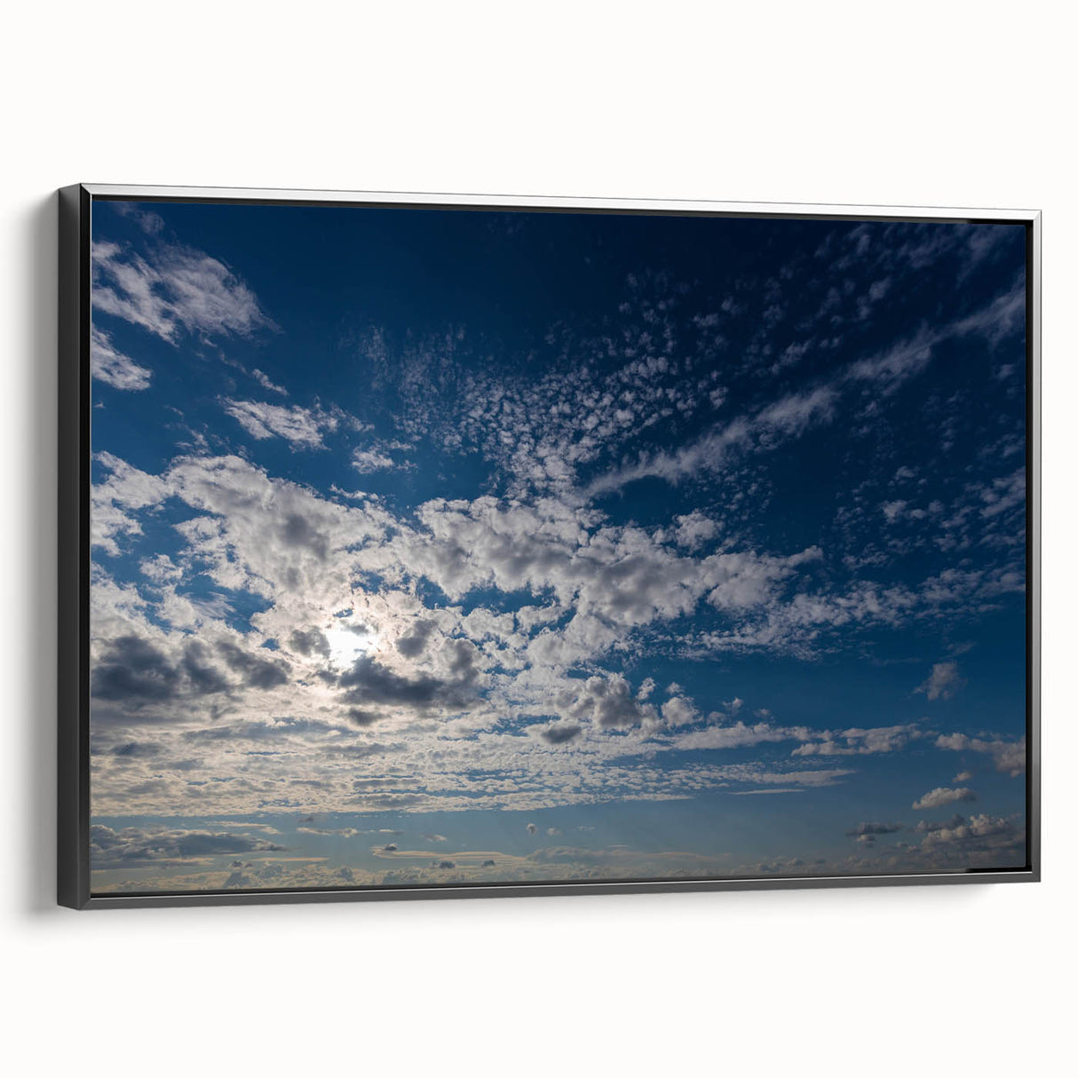 Framed canvas wall art showcasing a vibrant landscape with dramatic skyscapes, featuring a sleek black frame, perfect for modern home decor and accentuating any space.