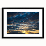 Framed wall art featuring a modern landscape design in vibrant colors, presented in a sleek black frame with a white mat, perfect for contemporary decor.